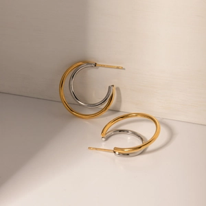 Modern dual-layer gold and silver C-shaped hoop earrings in polished stainless steel