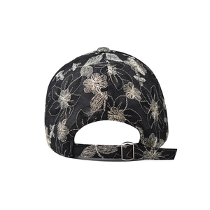 Detail of black lace baseball cap back view with floral embroidery and metal buckle