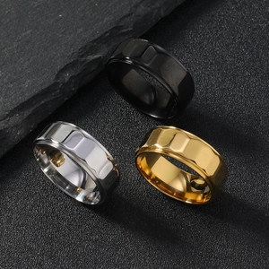 Detailed view of 8mm faceted stainless steel rings in black, silver, and gold finishes