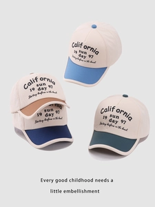 Detail of multi-color block kids baseball caps with retro California sun lettering