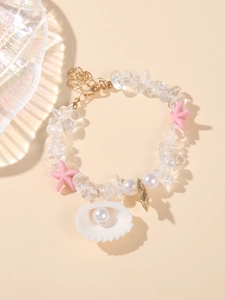 Detail of beach bracelet featuring shell with pearl, starfish, and clear stone beads