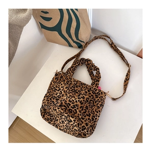 Detail of leopard print crossbody bag with ruched handle and fine shoulder strap