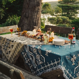 Bohemian woven outdoor picnic blanket with geometric tribal patterns and fringe edge