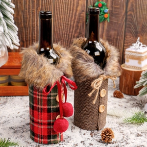 Christmas wine bottle covers with red plaid and brown patterns on a snowy festive table