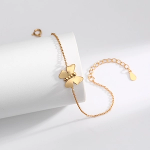 Elegant gold butterfly pendant bracelet on white display stand with adjustable chain