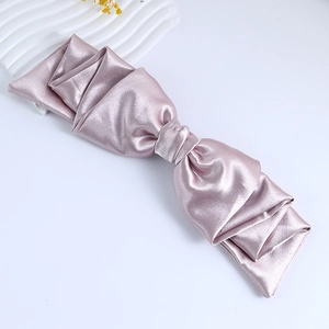 Elegant pink satin bow hair clip for women with silky texture on clean white background