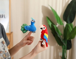 Close-up of plush peacock and parrot finger puppets for storytelling and interactive play