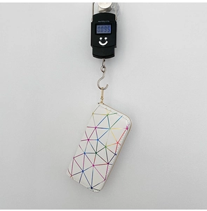 Digital scale showing light weight of 0.095kg for holographic geometric long wallet