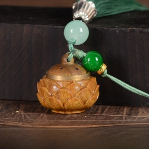 Detail of hand-carved lotus wooden sachet with green tassel and bead, size 24x26mm