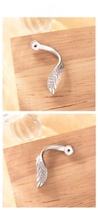 Detailed close-up of a silver angel wing earring set with sparkling cubic zirconia stones