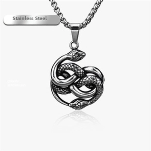 Detailed macro view of vintage stainless steel double-headed snake pendant with scales