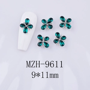 Macro view of 9x11mm emerald green butterfly nail art charms with silver alloy base