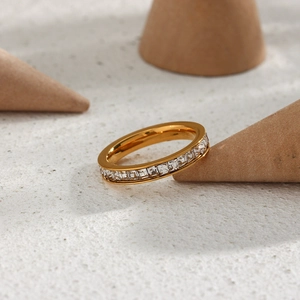 Detail of 18K gold plated eternity band ring with square-cut sparkling cubic zirconia