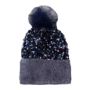 Close-up of navy sequined knit hat with grey plush cuff and fluffy top pom-pom detail