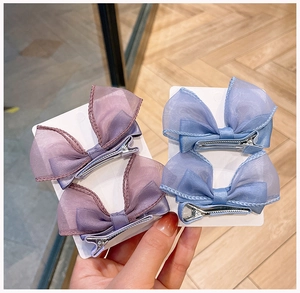 Detail of girls' 3D mesh bow hair clips in blue and purple on display cards