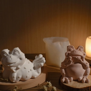 Artistic frog shaped candles and handmade plaster crafts on rustic wood tray decor