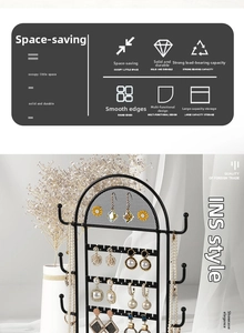 Detail of black arched metal jewelry stand with multi-layer grid and earring hooks