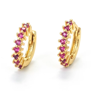 Close-up of 18K gold plated huggie earrings featuring row of pink cubic zirconia stones