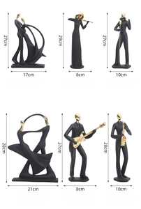 Detail of matte black abstract music and dance figurines with gold electroplated accents