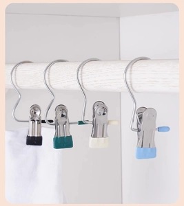 Detail of four colorful stainless steel hanging clips with anti-slip rubber coating