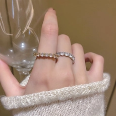 Close-up of gold and silver sparkling eternity rings with zirconia stones on hand