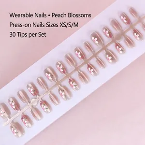 Detail view of pink peach blossom press-on nails in 30 pieces with XS, S, M size options
