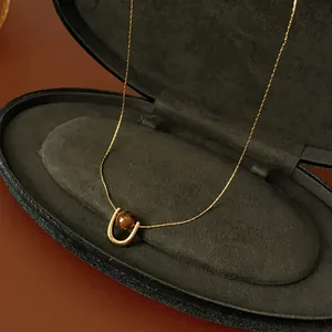 Titanium steel tiger eye pendant necklace on gold rope chain inside velvet jewelry box