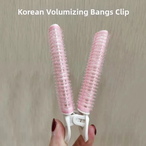 Close-up of pink and white hair root clip for volumizing bangs and styling hair