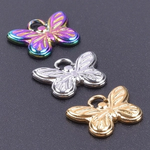 Detailed view of three butterfly pendants in gold, silver, and rainbow stainless steel finish