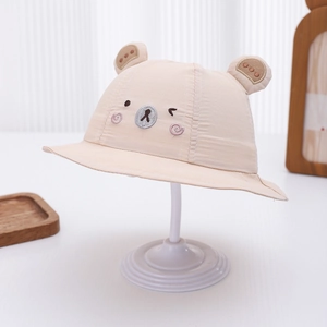 Detail of baby sun hat with cute 3D bear ears and face embroidery in beige cotton