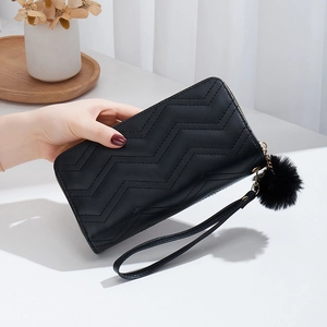 Elegant black wave-patterned quilted long wallet with a soft pompom and wrist strap