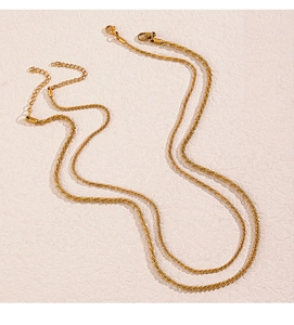 Macro detail of gold stainless steel shimmering star necklace with lobster clasp