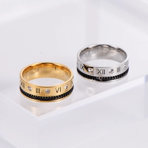 Macro detail of stainless steel Roman numeral ring with chain inlay and crystals