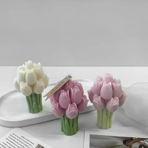 Detailed view of handmade tulip-shaped scented candles in pink and white wax finish