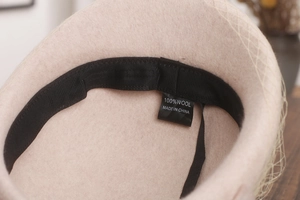 Detail view of the interior sweatband and 100% wool material label on the beret