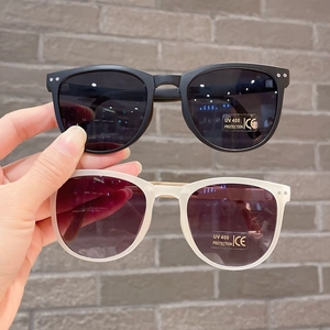 Close-up of foldable kids sunglasses in black and clear white with UV400 protection