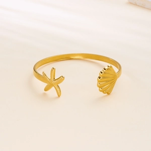Golden stainless steel open bangle featuring vintage starfish and seashell ornaments