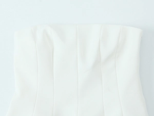Detailed view of the neckline and vertical seams on a white strapless tube top