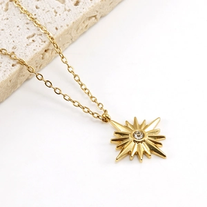 Detailed close-up of 18K gold-plated sunflower pendant with a sparkling central zircon stone