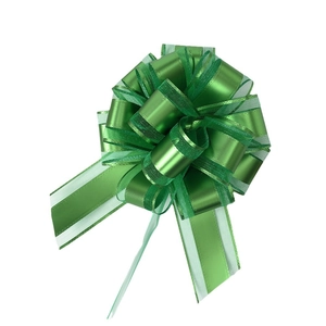 Green organza gift bow with metallic ribbon and white decorative stitching for Christmas