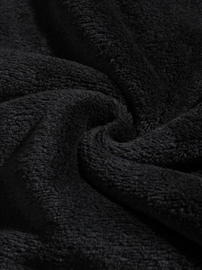 Detail shot of the thick black coral fleece fabric showing soft and warm plush texture