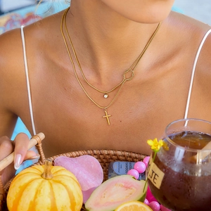 Detailed view of 18K gold double-layer necklace with cross pendant and round zircon