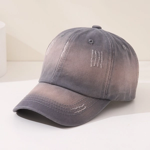 Close-up of vintage washed grey gradient baseball cap with distressed torn fabric details