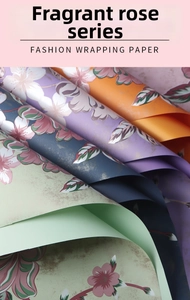 Close-up of matte waterproof flower wrapping paper with pink rose and gold foil patterns
