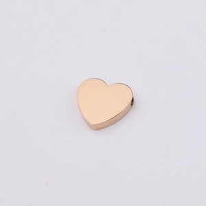 Macro view of a single rose gold stainless steel heart charm bead with smooth mirror finish