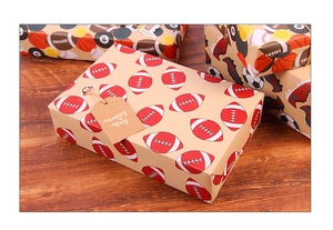 Detail of vintage kraft paper gift box with American football pattern and hemp rope tag
