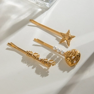 Detail of 18k gold flower hair clips with sea shell, starfish designs and white pearls