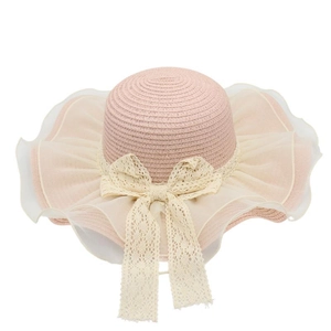 Detailed texture of woven straw sun hat with delicate lace bow and organza brim