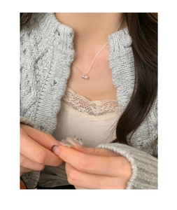 Close-up of minimalist S925 silver necklace with freshwater pearl worn on model neck