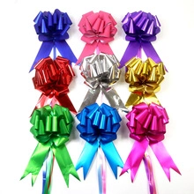 Selection of 9 colorful metallic gift pull bows with long ribbon tails on white background